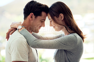 Buy stock photo Shot of a young couple sharing a tender moment