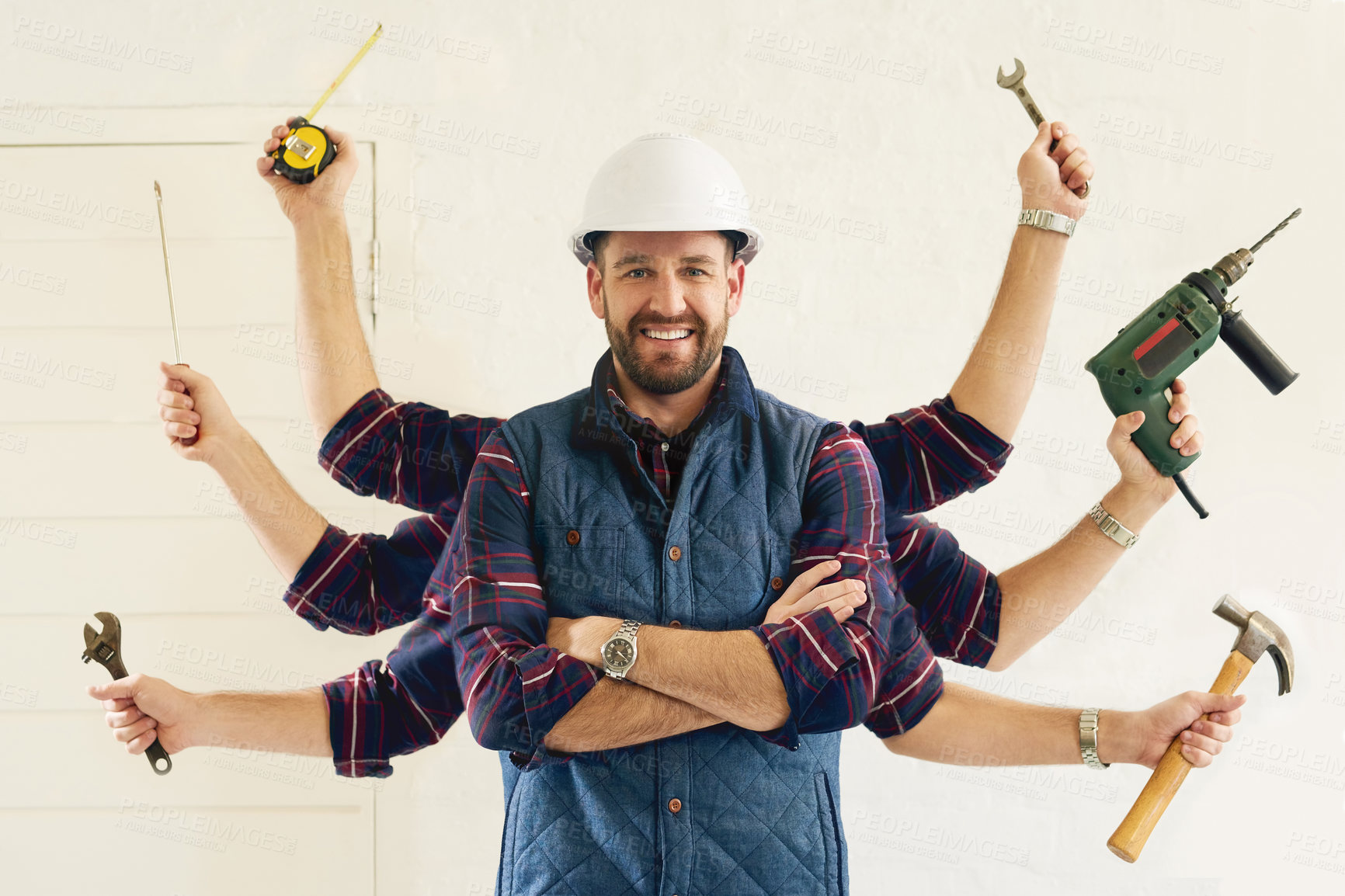 Buy stock photo Portrait of a handsome young handyman tools in multiple hands