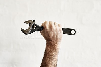 Buy stock photo Shot of an unrecognizable handyman holding up a monkey wrench
