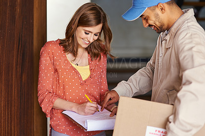 Buy stock photo Cropped shot of an attractive young woman signing for her delivery
