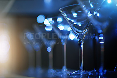 Buy stock photo Cocktail glasses, blue light and dark background in nightclub ready for birthday party celebration, new years or nightlife social event. Empty glass, blue lens flare and happy hour or pub counter
 
