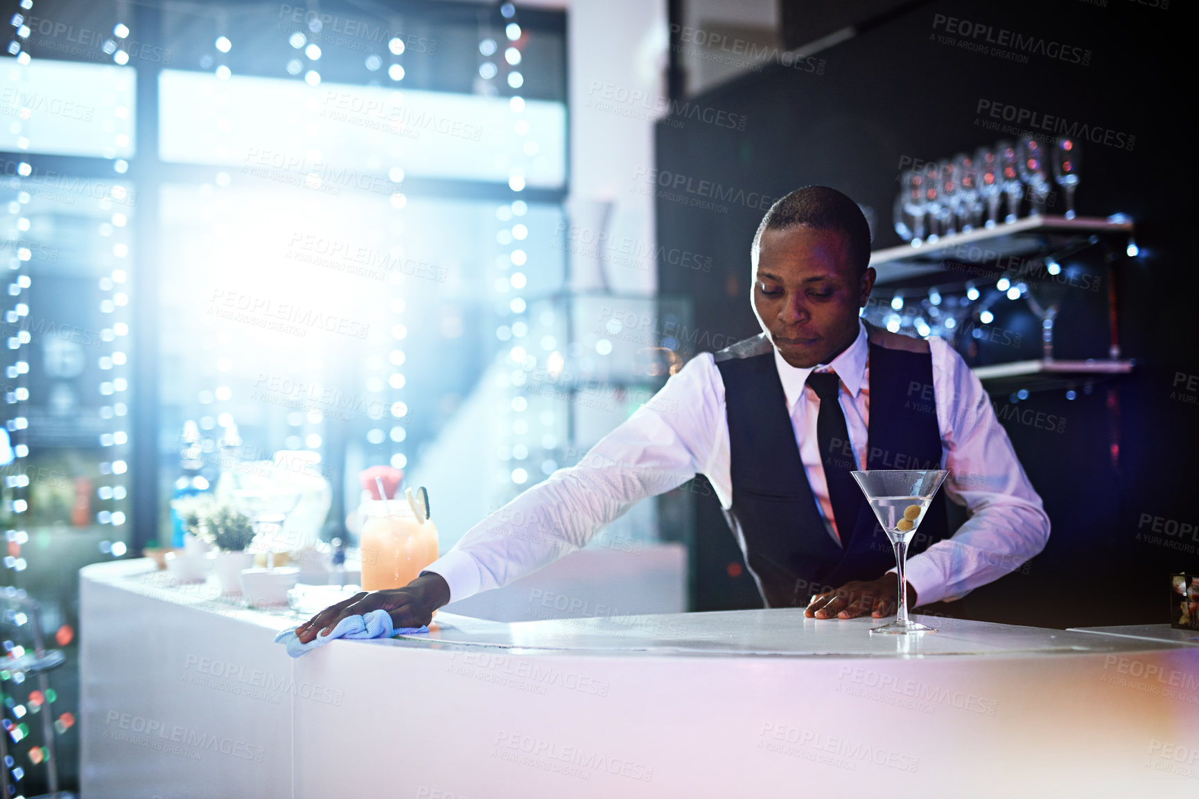 Buy stock photo Cropped shot of a well-dressed bartender standing behind the counter