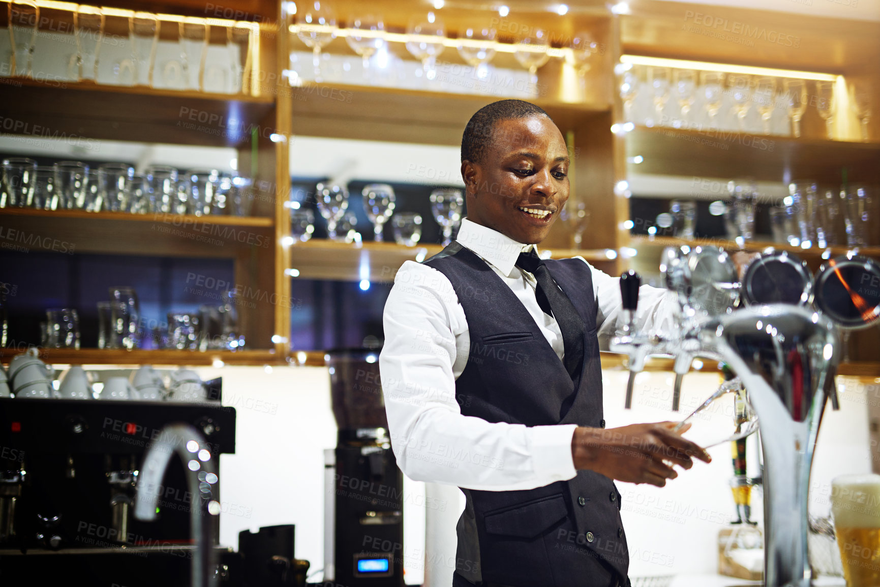 Buy stock photo Cropped shot of a well-dressed bartender standing behind the counter