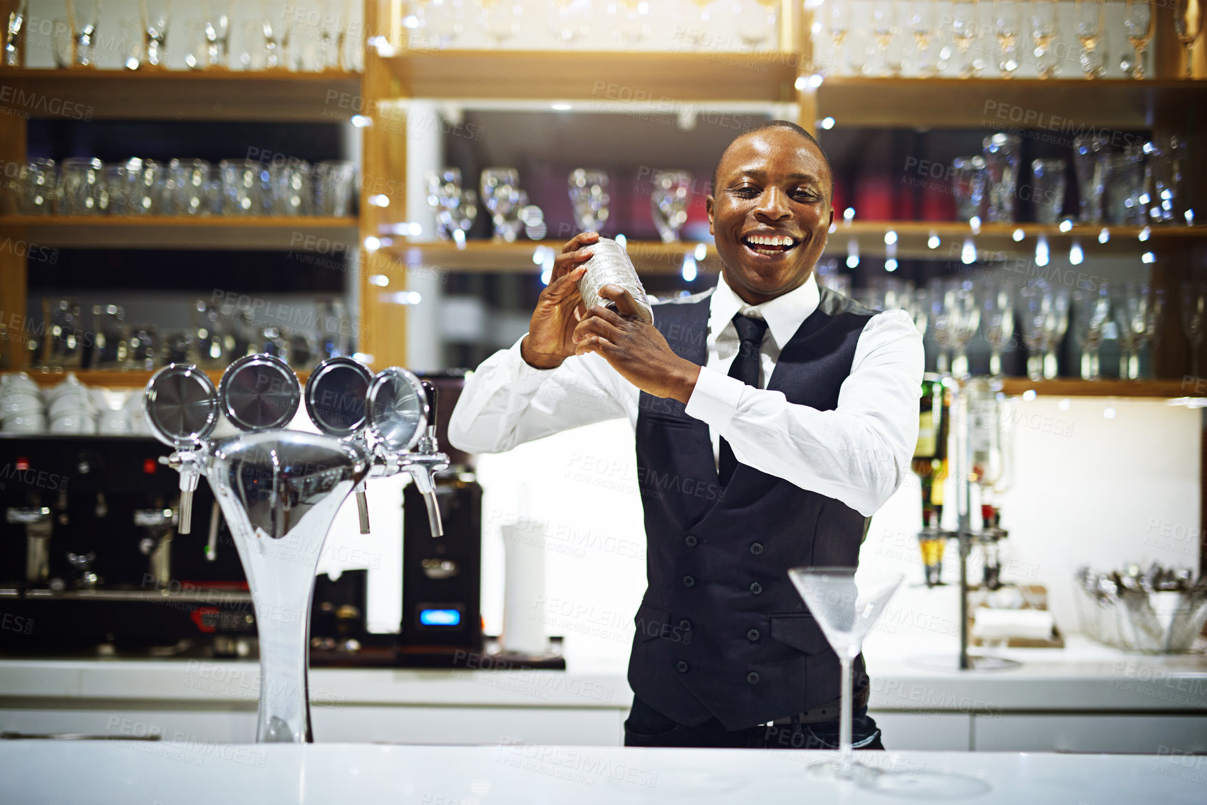 Buy stock photo Cropped shot of a well-dressed bartender standing behind the counter