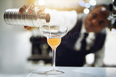 Buy stock photo Cropped shot of a bartender making a cocktail