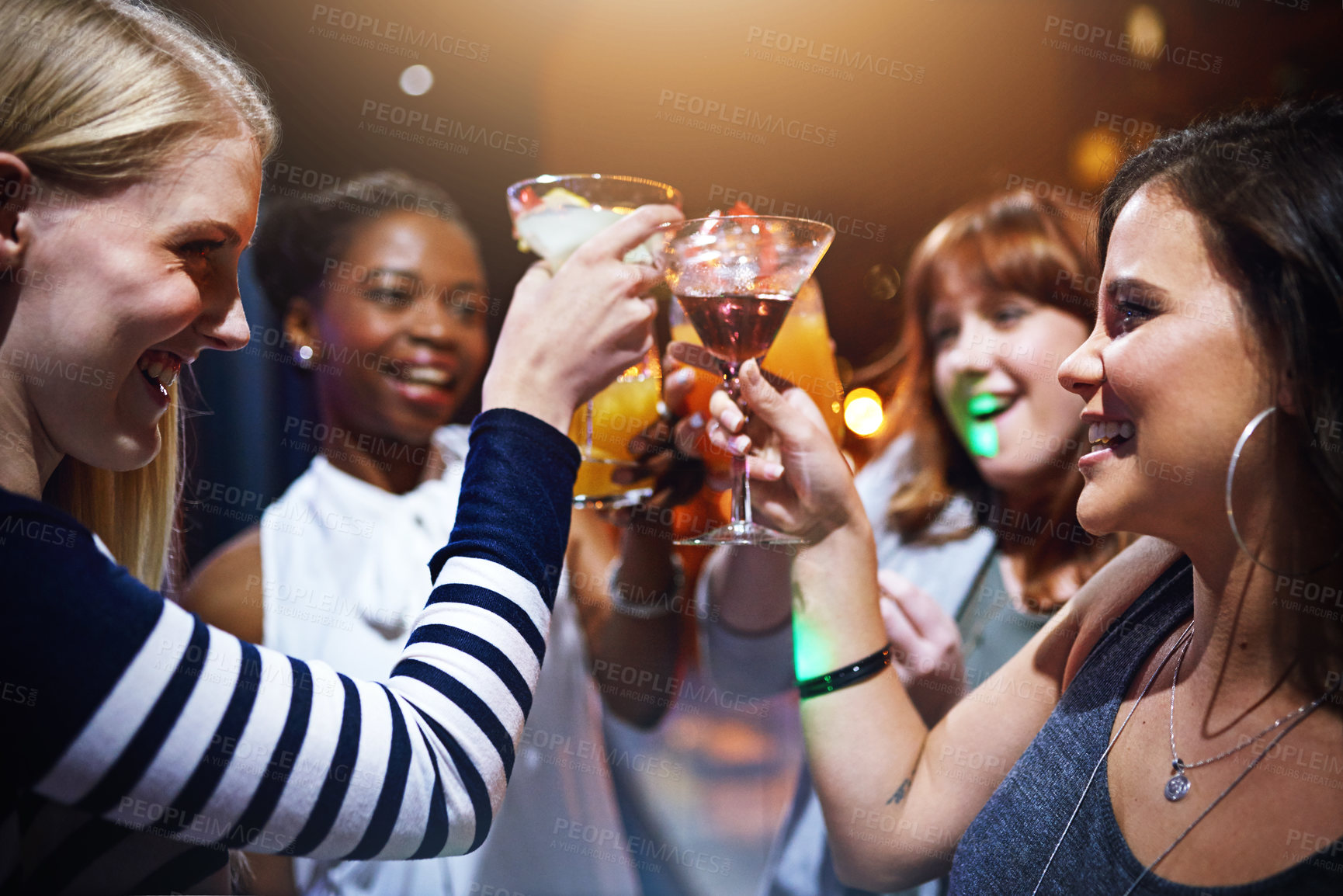 Buy stock photo Women, happy and cheers in club for party or event for nightlife, bonding and friendship with fun or laughter. Alcohol, toast and raising cocktail with excitement for celebration, together and drink