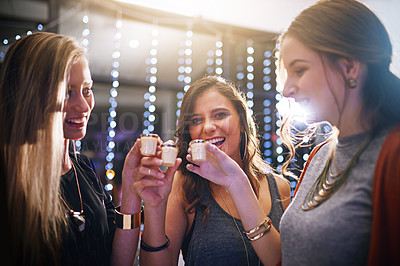 Buy stock photo Cropped shot of a group of friends having shots together at a party
