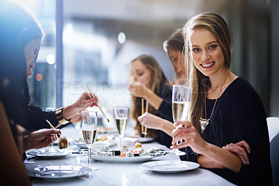 Buy stock photo Portrait, dinner party and champagne with a woman and friends sitting around a table in celebration of the new year. Food, party and alcohol with a female and friend group enjoying a meal together