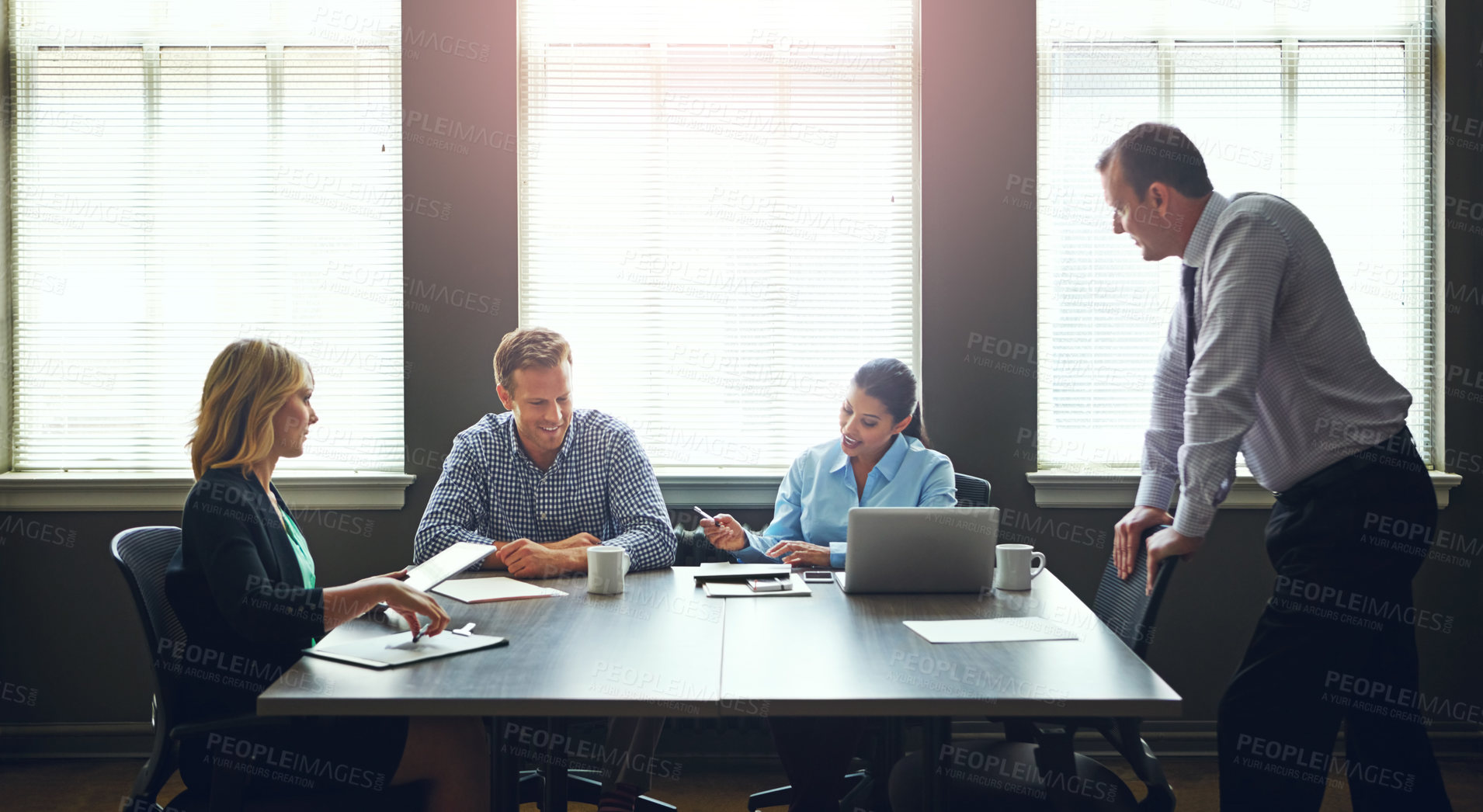 Buy stock photo Shot of a group of colleagues having a meeting in the boardroom at work