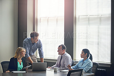 Buy stock photo Shot of a group of colleagues having a meeting in the boardroom at work