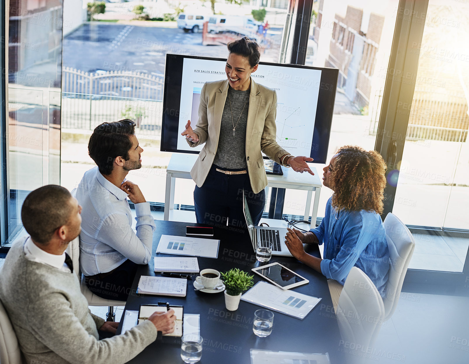 Buy stock photo Happy woman, coach and discussion with team in meeting, presentation or conference on project at office. Female person or speaker talking to employees with paperwork, documents or screen at workplace