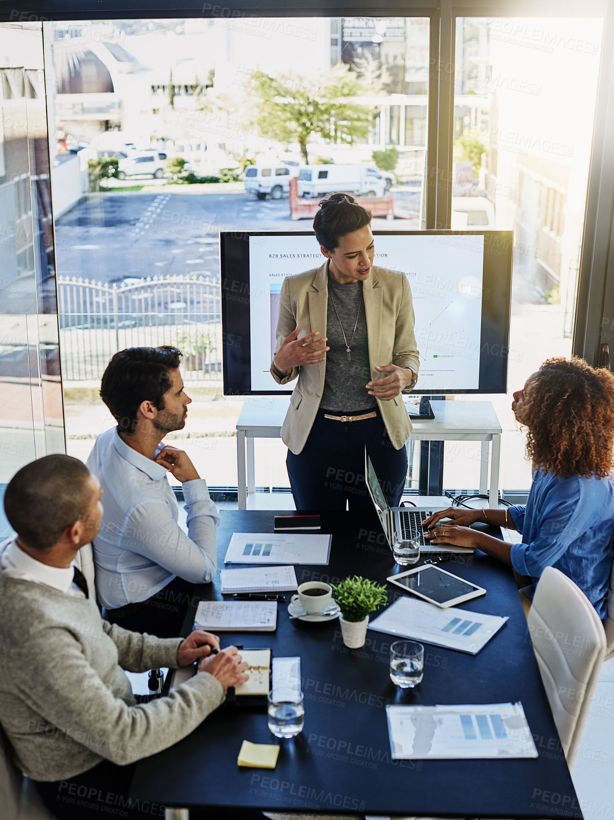 Buy stock photo Business woman, coaching and discussion with team in meeting, presentation or conference at office. Female person or speaker talking to employees with paperwork, documents or screen at workplace