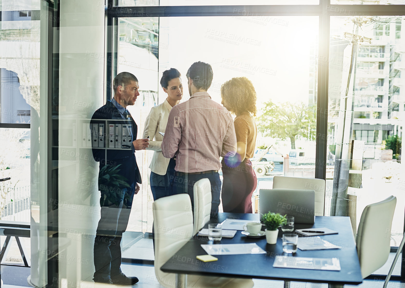 Buy stock photo Shot of a group of colleagues meeting in the boardroom