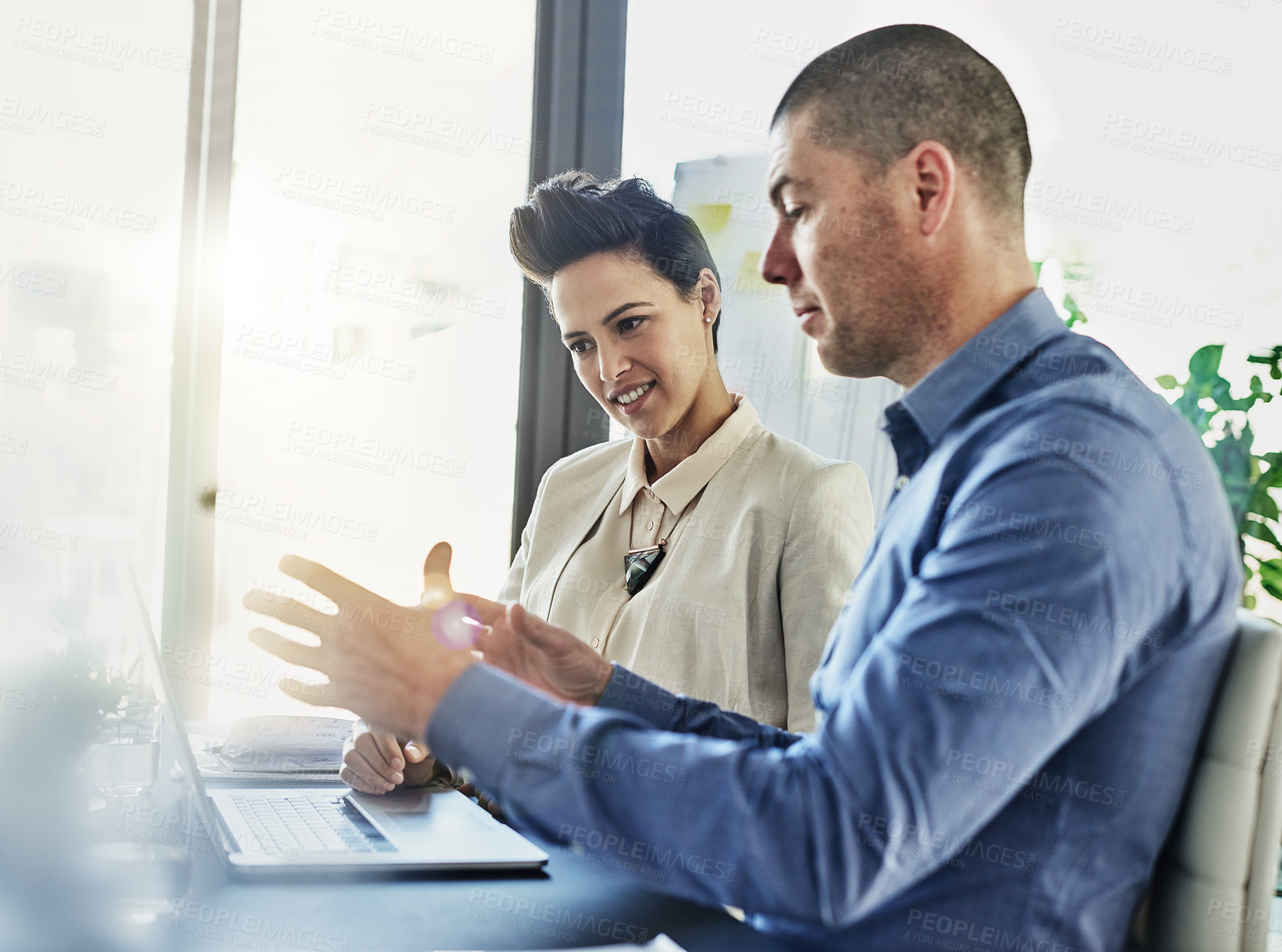 Buy stock photo Shot of two colleagues meeting in their office