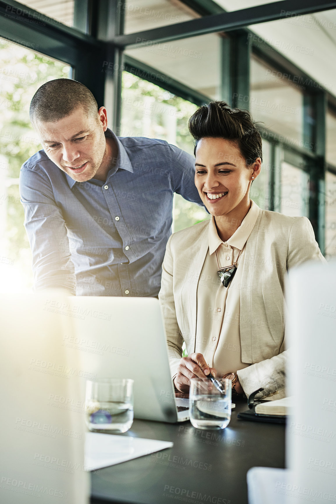 Buy stock photo Shot of two colleagues meeting in their office