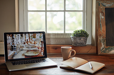 Buy stock photo Shot of a table at home with a laptop, notebook and pen