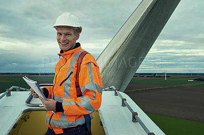 Buy stock photo Portrait of a young engineer inspecting a wind turbine