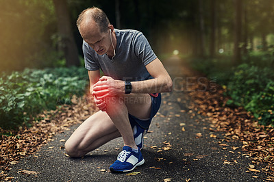 Buy stock photo Knee pain, jog and man in nature for exercise, rest and check injury on trail. Male runner, kneel and overlay for hurt from fitness, running and arthritis in leg with earphones and sportswear