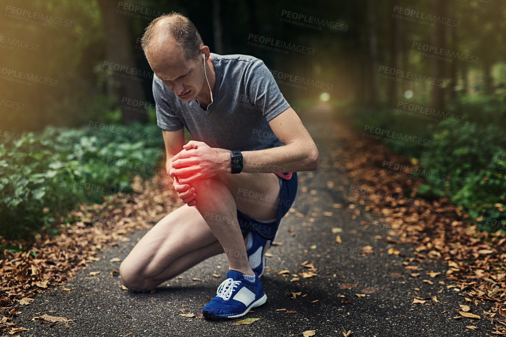 Buy stock photo Knee pain, jog and man in nature for exercise, rest and check injury on trail. Male runner, kneel and overlay for hurt from fitness, running and arthritis in leg with earphones and sportswear