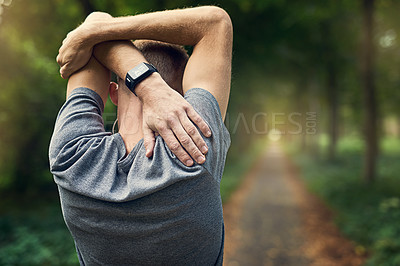 Buy stock photo Rearview shot of a man warming up before a run