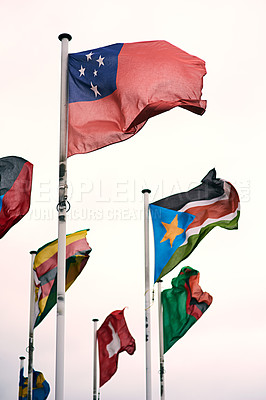 Buy stock photo Country, wind and flags outdoor, sky and blowing in pole, government and respect for symbol and power. Pride, color and hanging for world, global and dedication of solidarity, diversity and identity