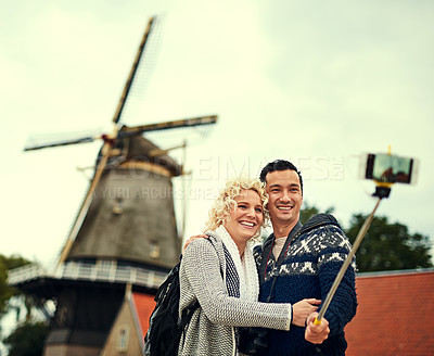 Buy stock photo Cropped shot of a young couple taking selfies while on vacation