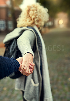 Buy stock photo Rearview shot of a young woman leading her husband through a foreign city