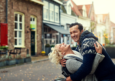 Buy stock photo Hug, laughing and love with couple in town of foreign city for holiday, travel or vacation together. Funny, romance or smile with happy man and woman in overseas neighborhood for bonding or getaway