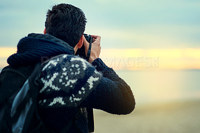 Buy stock photo Beach, man and camera photography at sunset on holiday, travel or summer vacation in Spain. Dslr picture, back view or person at ocean outdoor for tourism, adventure or journey in nature by sea water