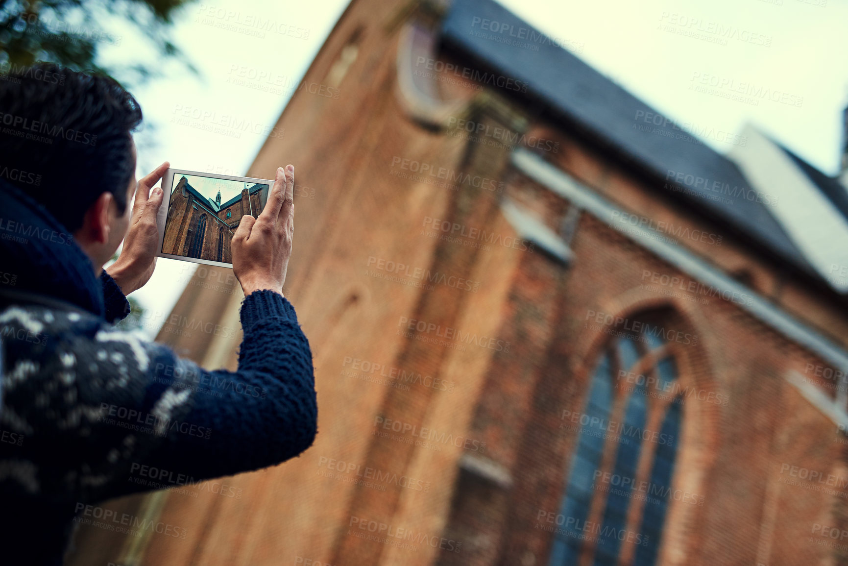 Buy stock photo Rearview shot of  a young man taking photographs while on vacation