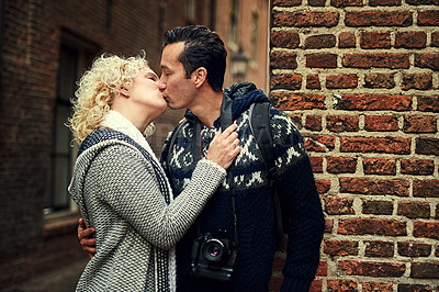 Buy stock photo Cropped shot of an affectionate young couple kissing while on vacation