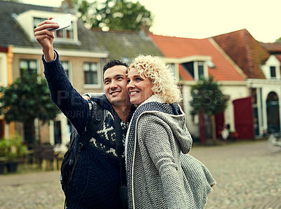 Buy stock photo Cropped shot of a young couple taking selfies while on vacation