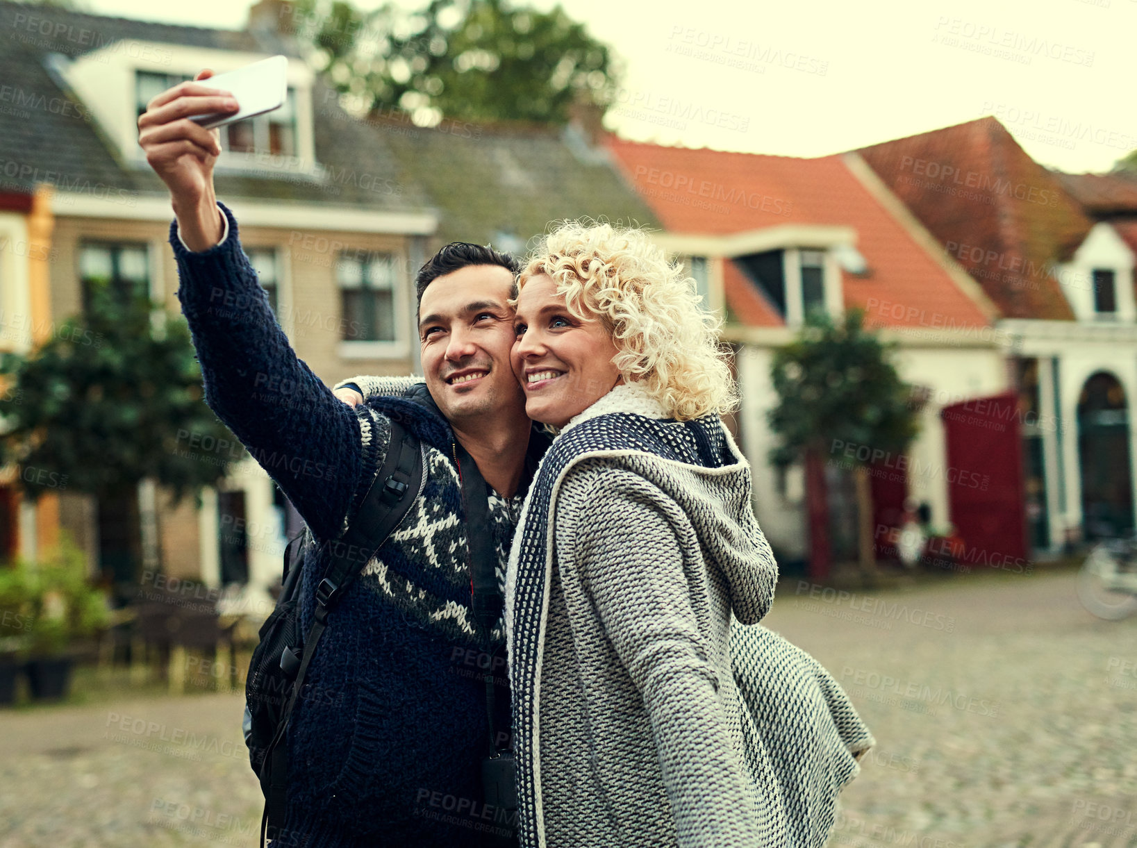 Buy stock photo Cropped shot of a young couple taking selfies while on vacation