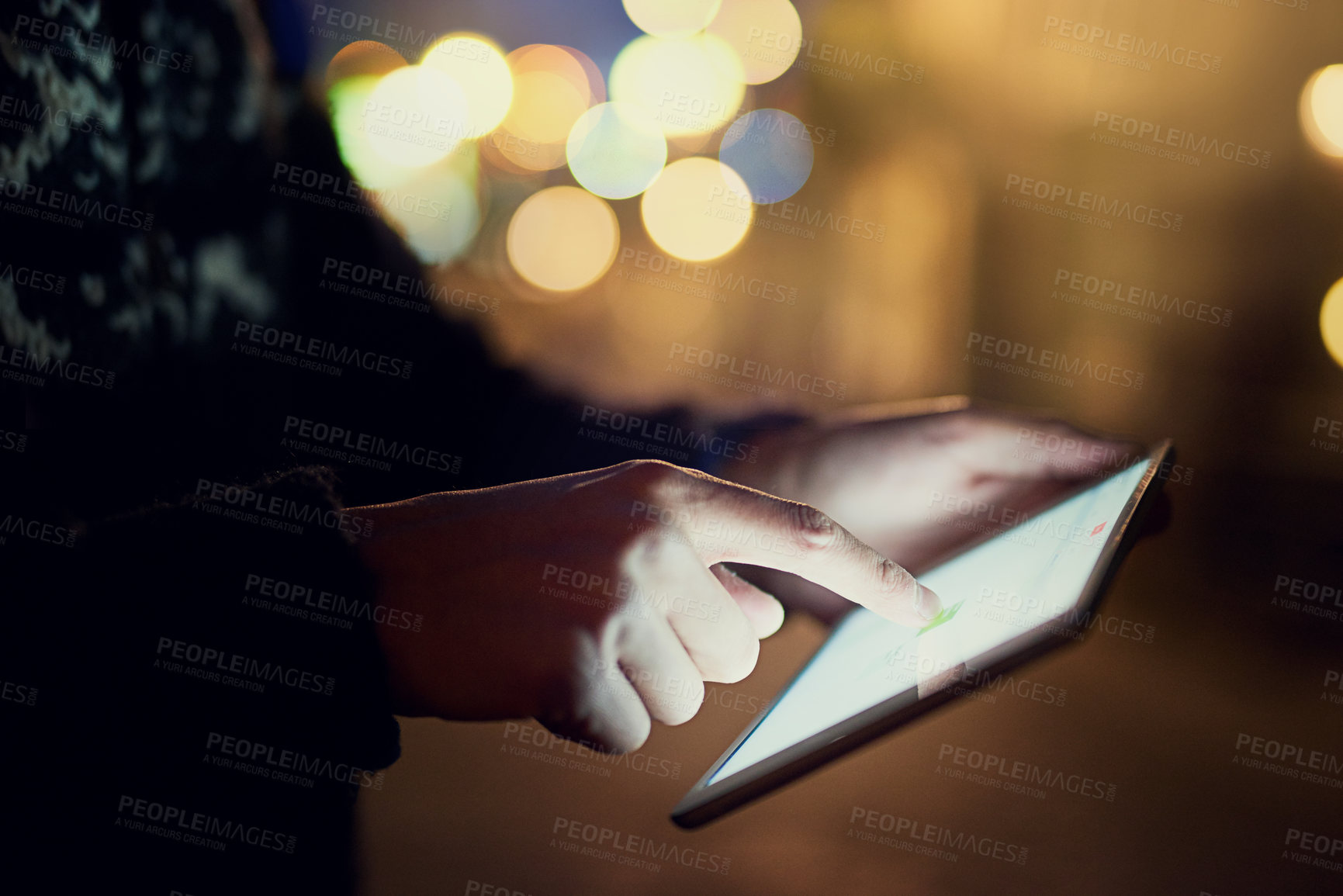 Buy stock photo Shot of an unrecognizable young man looking at photographs on his tablet while on vacation