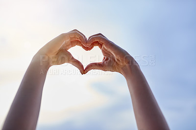 Buy stock photo Cropped shot of hands making a heart shape against a blue sky