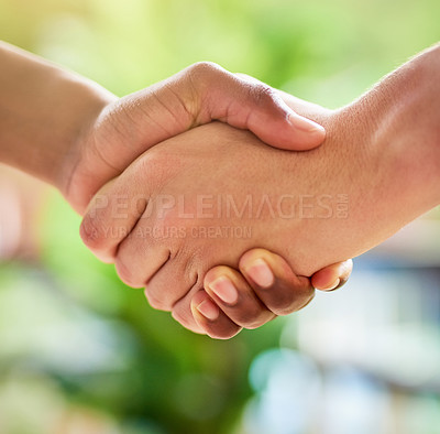 Buy stock photo Cropped shot of two unidentifiable people shaking hands outside