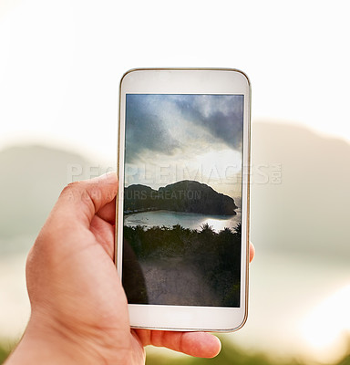 Buy stock photo Cropped shot of an unidentifiable person taking a picture with a smartphone while on holiday