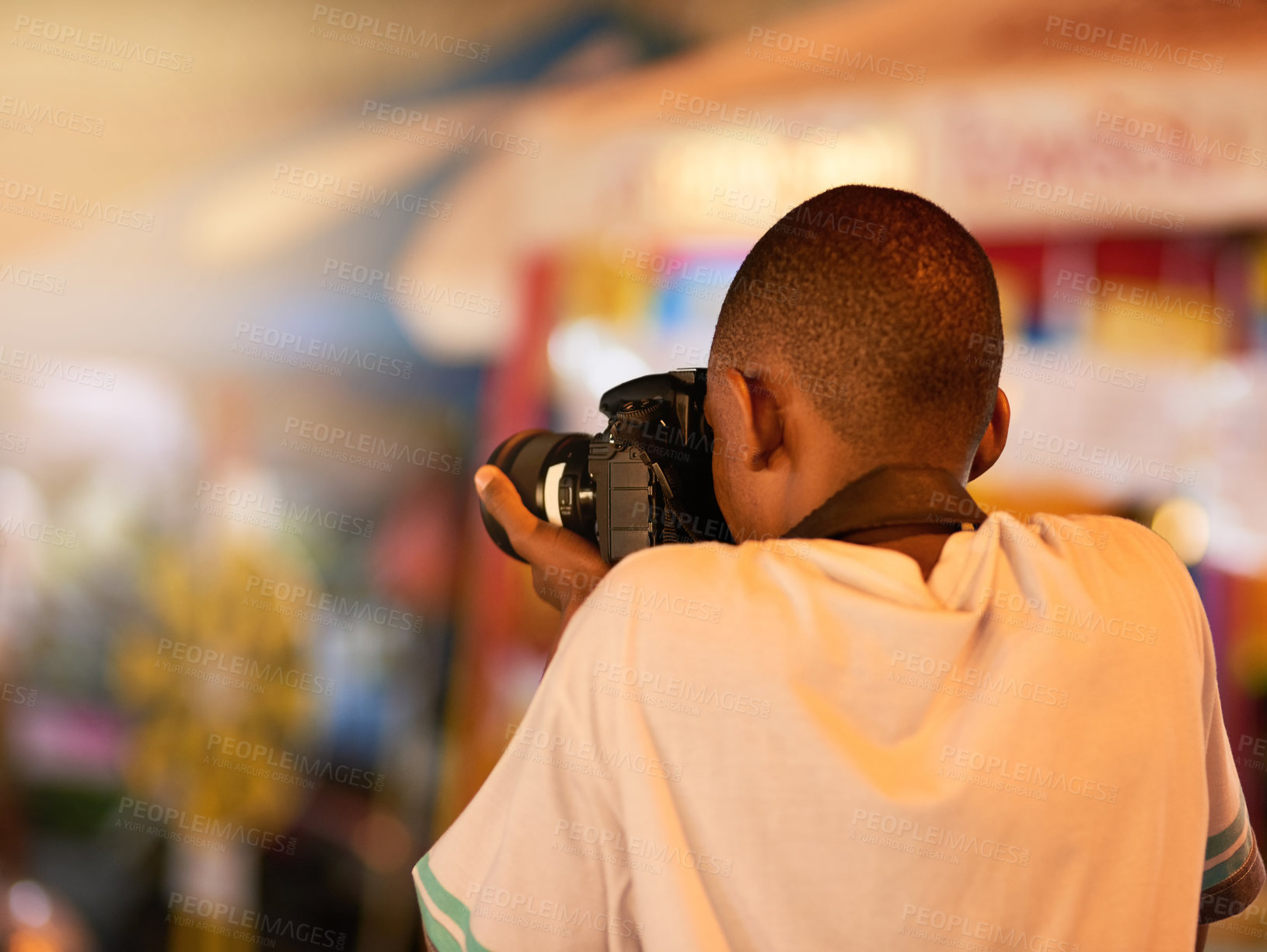 Buy stock photo Rearview shot of a young man taking pictures while touring a foreign city