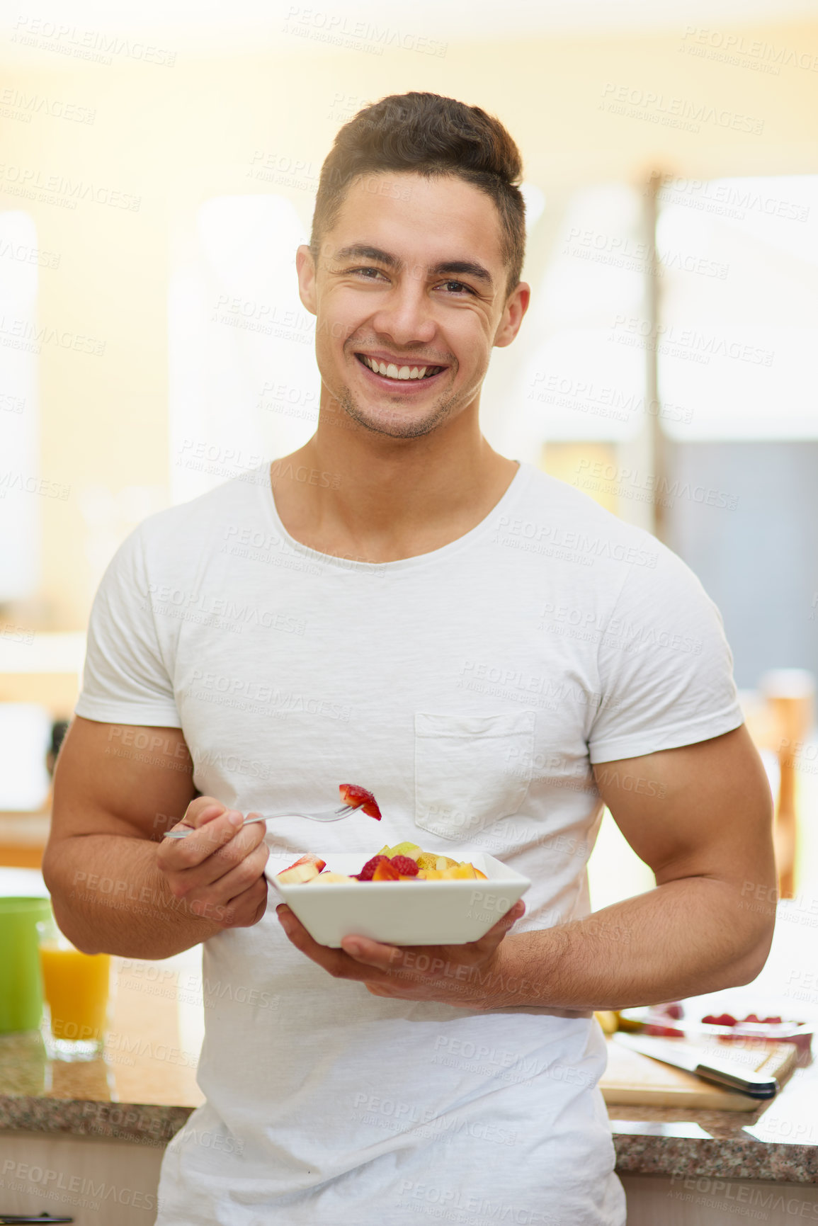 Buy stock photo Cropped shot of a young man eating a fruit salad