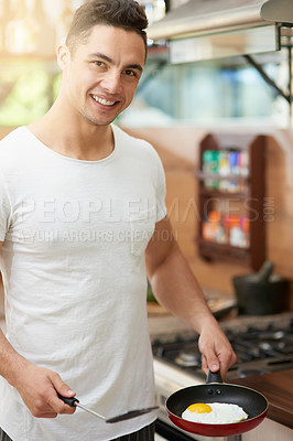 Buy stock photo Cropped shot of a young man preparing breakfast at home