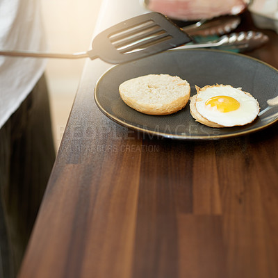 Buy stock photo Hands, egg and bread in kitchen for breakfast in home with diet, wellness and nutrition on plate. Person, meal prep and ready with food, natural protein and bagel for start in morning at apartment