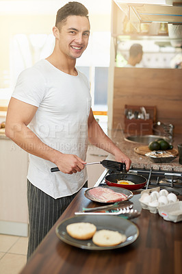 Buy stock photo Cropped shot of a young man preparing breakfast at home
