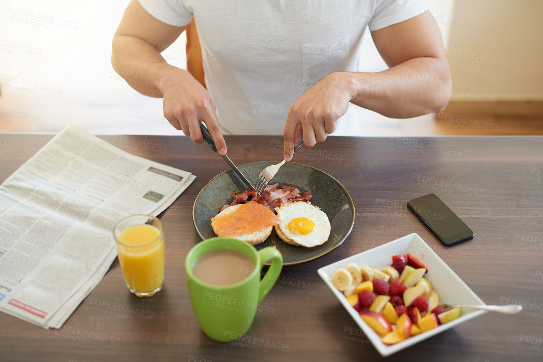 Buy stock photo Cropped shot of a bachelor enjoying breakfast at home
