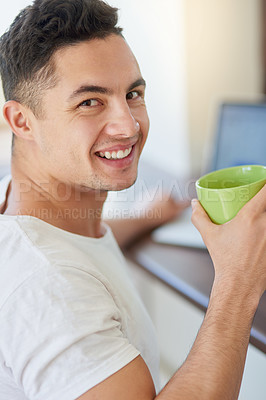 Buy stock photo Cropped shot of a young man enjoying his morning coffee