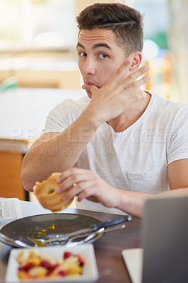 Buy stock photo Cropped shot of a bachelor enjoying breakfast at home