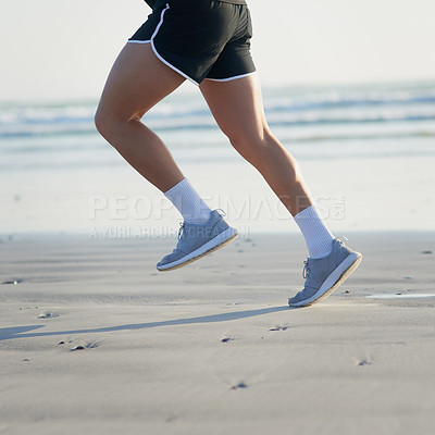 Buy stock photo Cropped shot of an unrecognizable young man running on the beach