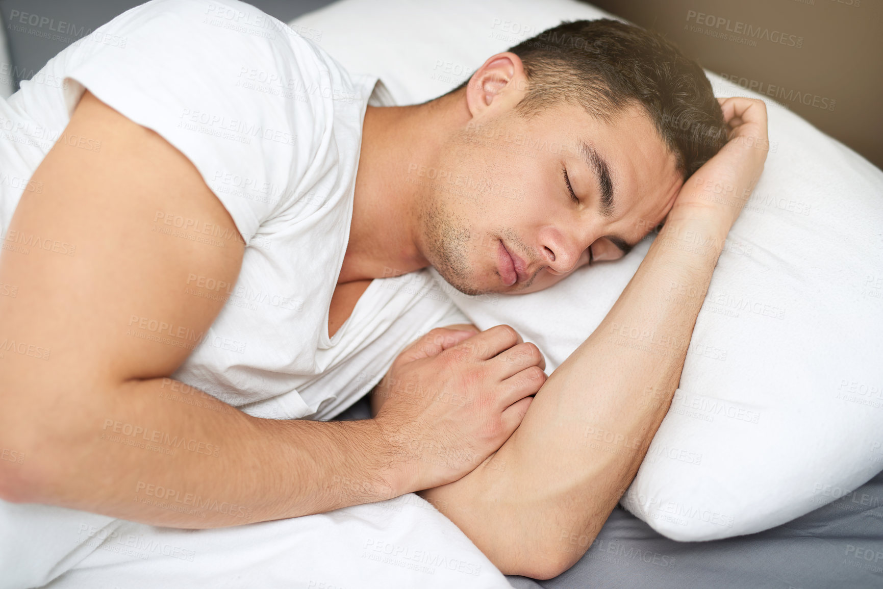 Buy stock photo Cropped shot of a handsome young man asleep in his bed