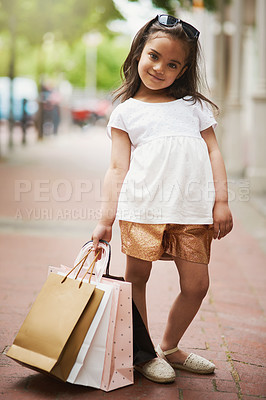 Buy stock photo Portrait, girl child and shopping bags outdoor with smile for fashion, retail and style development. Happy, kid and apparel carrier outside with clothes or gift for summer trend, discount and buy