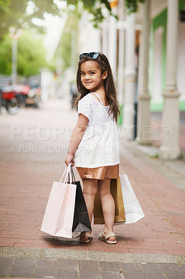 Buy stock photo Portrait, girl child and shopping bags outdoor with smile for fashion, retail and style development. Happy, kid and apparel carrier outside with clothes or gift for summer trend, discount and buy