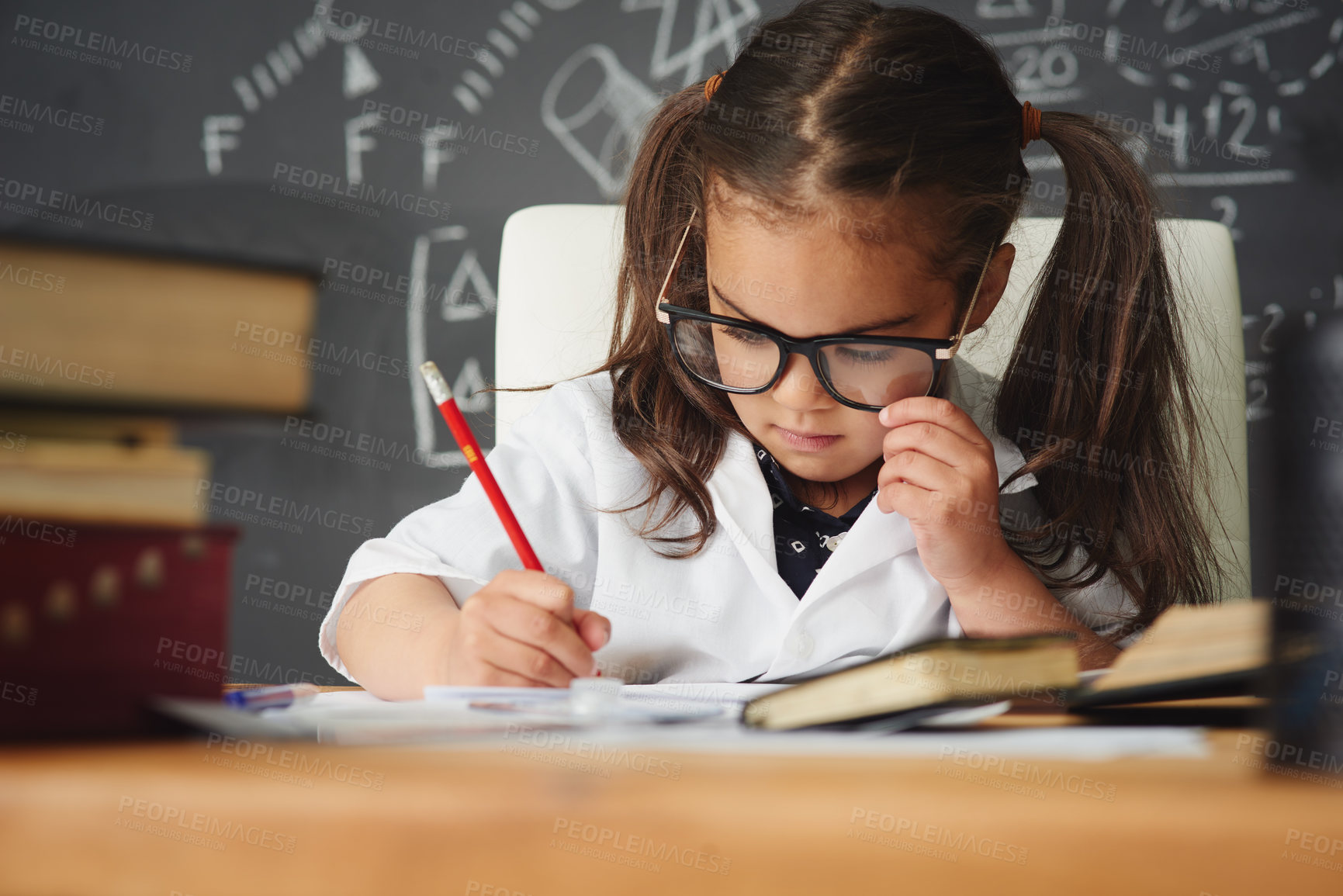 Buy stock photo Shot of an academically gifted young girl working in her classroom